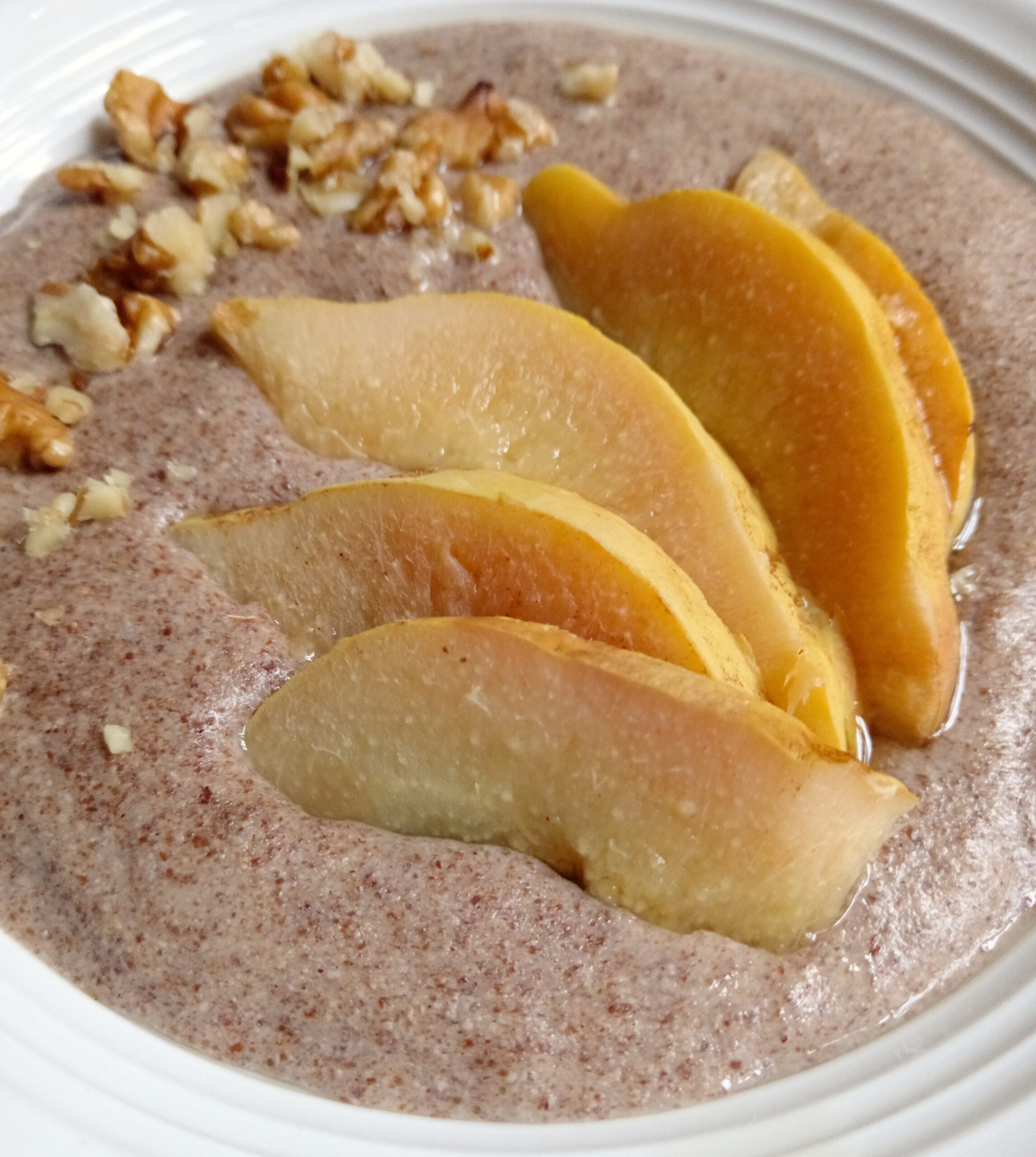 Keto-style Maltabella flaxseed porridge topped with poached quince slices and chopped walnuts