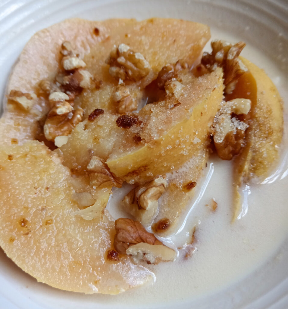 Poached quince served with a creamy yogurt sauce made from yogurt and spiced quince syrup.