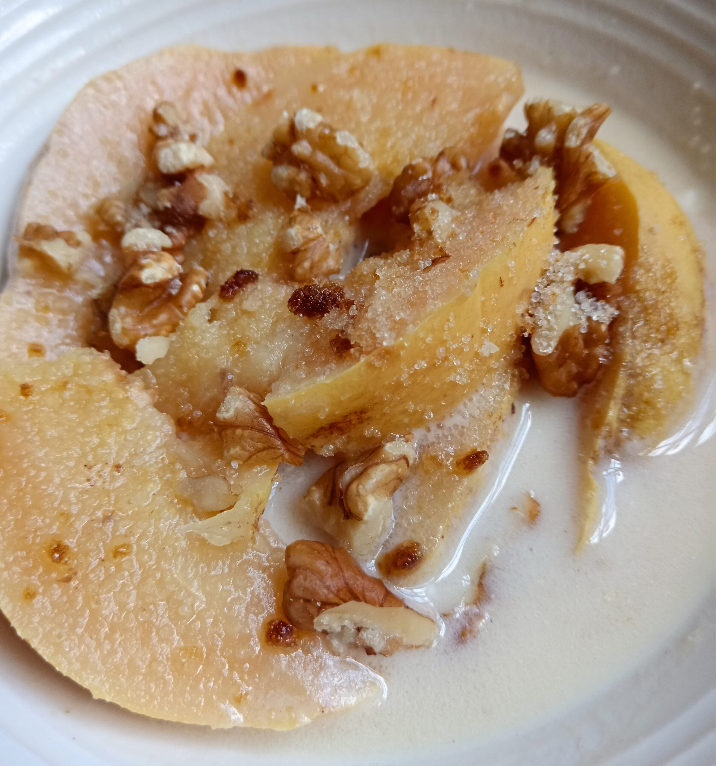 Poached quince served with a creamy yogurt sauce made from yogurt and spiced quince syrup.