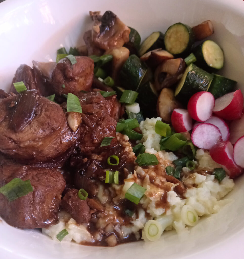Filipino-inspired pork tenderloin adobo with cauliflower mash, sautéed zucchini, mushrooms, spring onion, and sliced radishes.