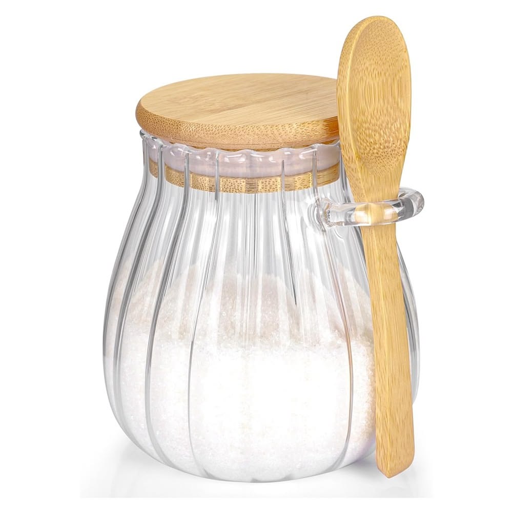 A sugar container with wooden spoon