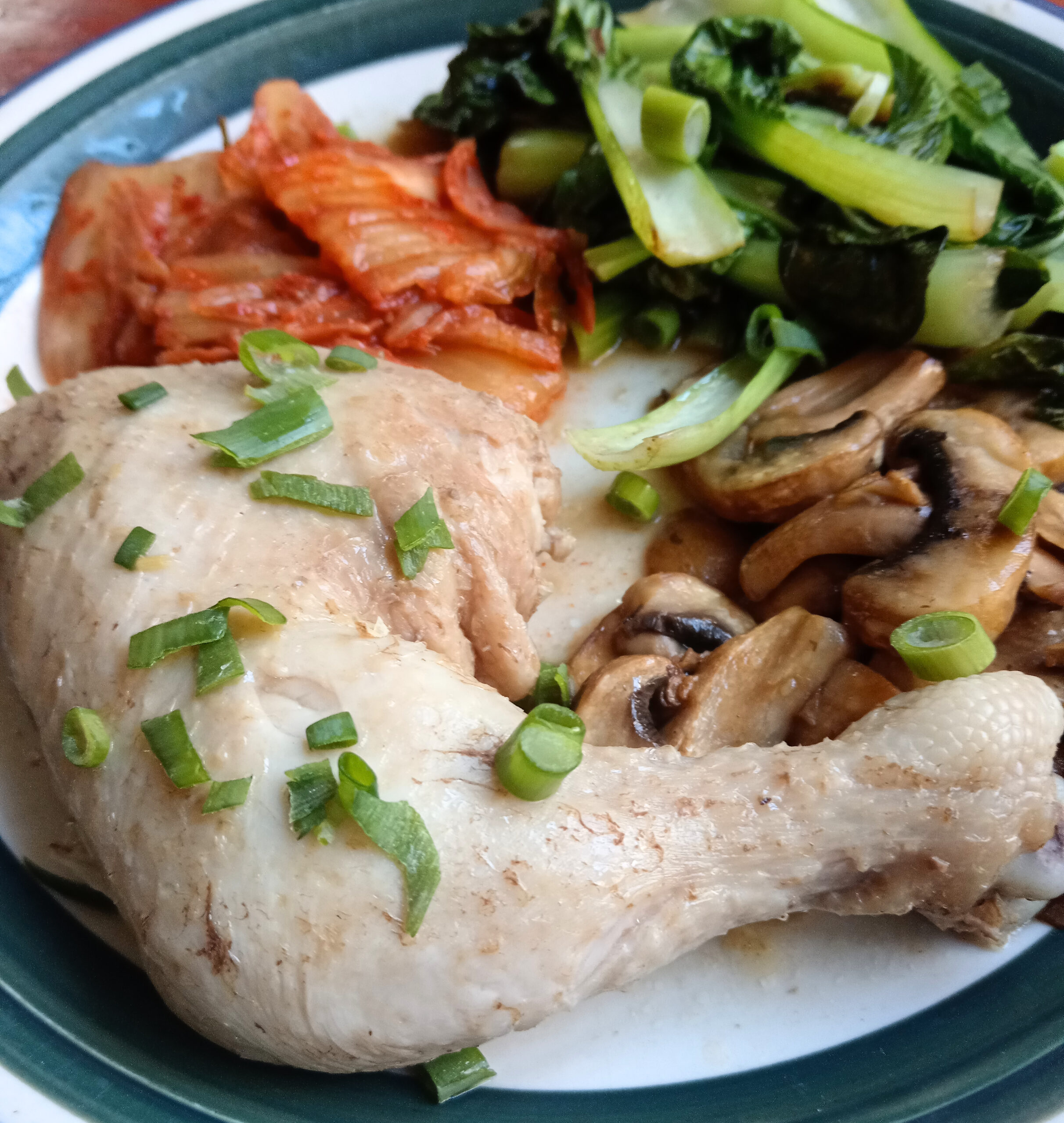 Lemongrass poached chicken with sautéed mushrooms, baby pak choi, kimchi and spring onion.